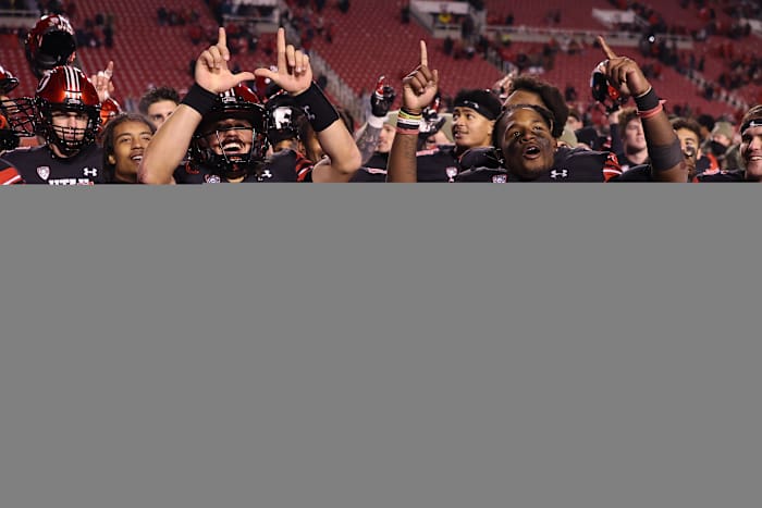 Utah Utes quarterback Cameron Rising (7) and running back Tavion Thomas (9) react to a win against the Stanford Cardinal at Rice-Eccles Stadium.
